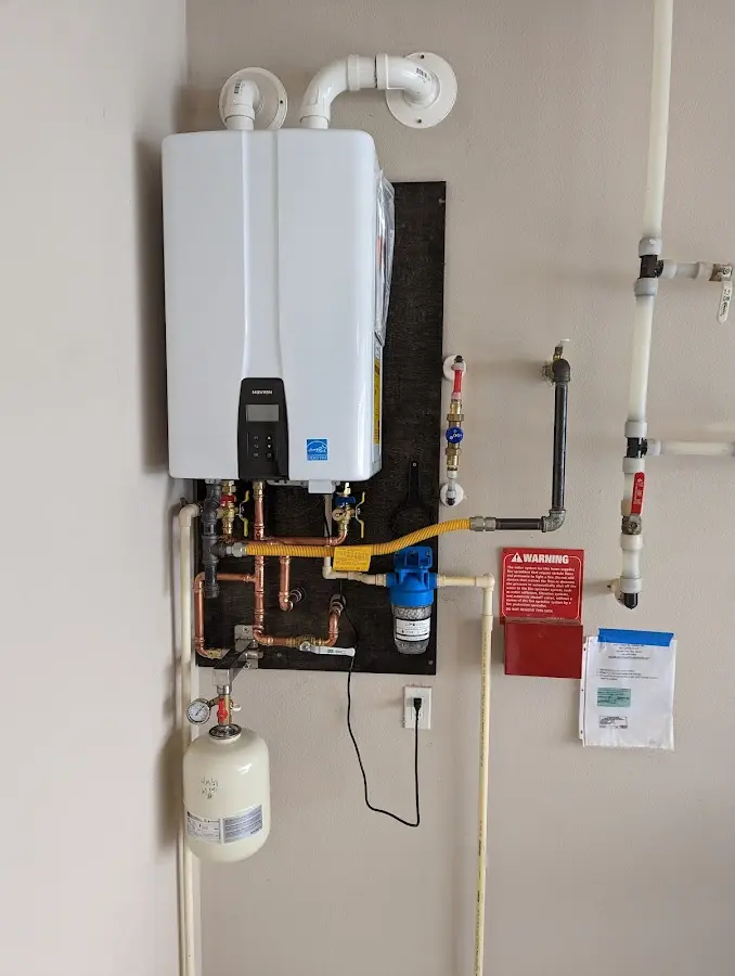 Professional plumber installing copper piping in a Greece home
